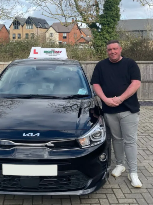 Jack standing beside a RightRay driving school car