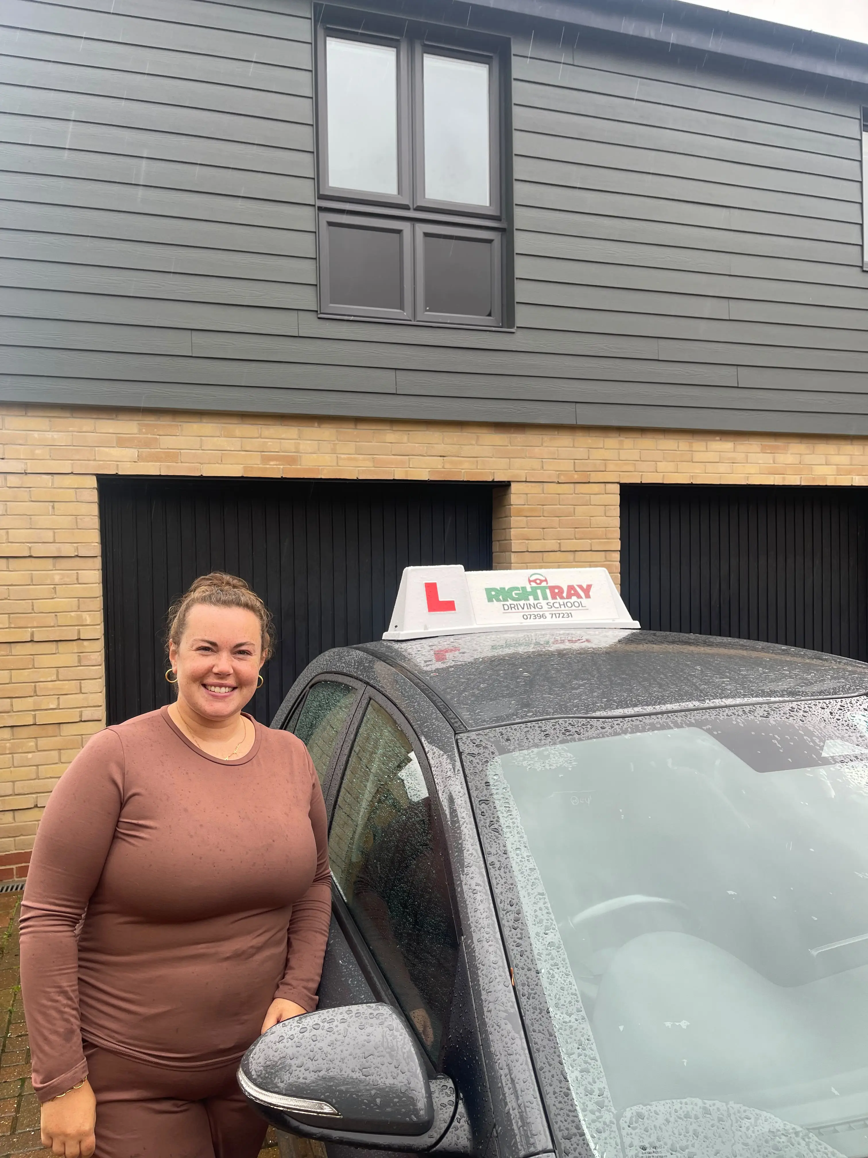 Sophie standing beside a RightRay driving school car